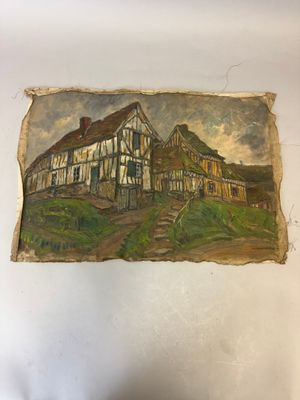 peinture représentant une vieille maison sur une feuille de papier posée sur une table