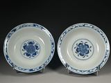 pair of blue and white plates with flowers on them