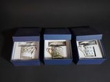 three boxed tea cups in a blue box on a black surface