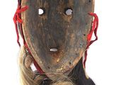 a wooden mask with long hair on a white background