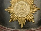 a black and gold hat with a gold star on it