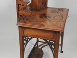 a small wooden table with a clock on top of it