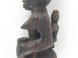 an image of a wooden sculpture of a man with a bird on his shoulder