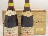 deux bouteilles de vin rouge sont posées devant une caisse en bois