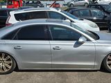 a silver car parked in a parking lot with other cars in the background
