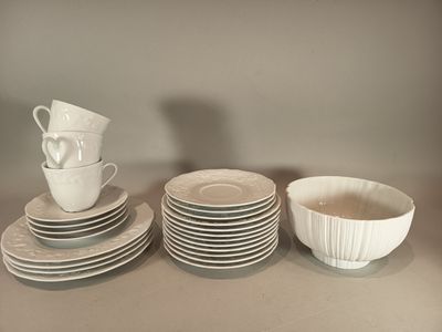 a lot of plates and cups sitting on a table
