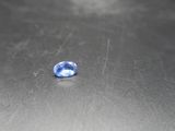 a blue sapphire stone sitting on top of a metal table