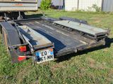 an image of a flatbed truck parked in the grass