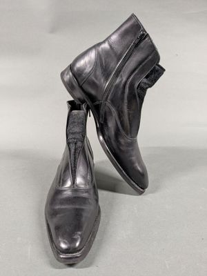 pair of men ' s black leather boots with zippers on them