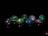 several oplites are arranged in a row on a black surface