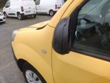 a yellow truck parked in a parking lot with other cars