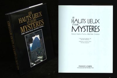 two books sitting on a table next to each other on a black surface