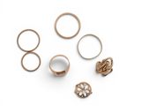 five different rings on a white surface