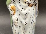 a figurine of a woman holding a child