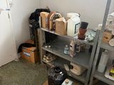 a small room with a lot of items on the shelves