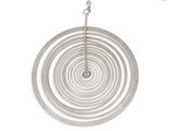 a circular object hanging from a chain on a white wall