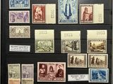 an old collection of stamps and stamps on display in a glass case