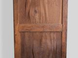 an image of a wooden cabinet with a door on top of it