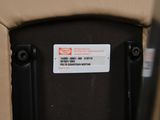 a close up of a car seat with a sticker on it
