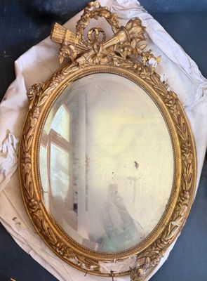 a mirror that is sitting on a table next to a cloth