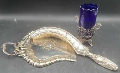a silver spoon and a blue glass on a table