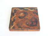 a small brown box with a design on it