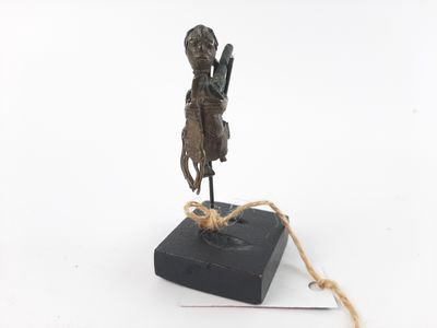 bronze statue of a man holding a sword on a black base