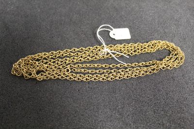 a close up of a gold chain with a tag on it