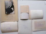 many old papers on a table with a picture of a man in a suit