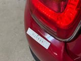 a close up of a red car with a sticker on it