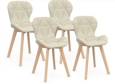 four chairs with wooden legs and a white upholstered seat