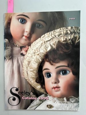 a picture of a book with a picture of two dolls