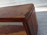 a small wooden table with a wooden shelf on top of it
