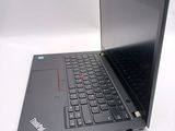 a laptop with a black keyboard on a white surface