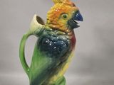 a colorful bird that is sitting on top of a pitcher