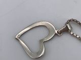 a bottle opener with a chain attached to it