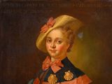 portrait of a young girl in a blue dress with a pink bow