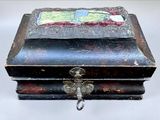 a small wooden box with a painting on it