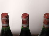 three bottles of wine that are sitting on a table