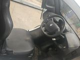 a golf cart with a steering wheel and a driver ' s seat