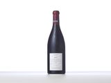 the bottle of red wine is sitting on the table