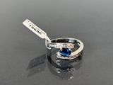 a ring with a blue stone on a black surface