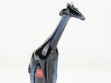 a black and blue giraffe figurine sitting on a white surface