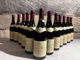 several bottles of wine lined up in a row on a table