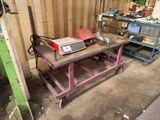 a table that has a machine on it in a garage