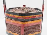an old red and black box with a handle on a white background