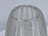 a clear plastic cup sitting on top of a white plate