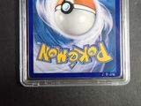 a pokemon card in a plastic holder on a table