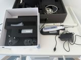 a white table with a box of electronics on it