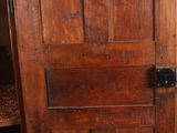 a wooden door that is open in a room